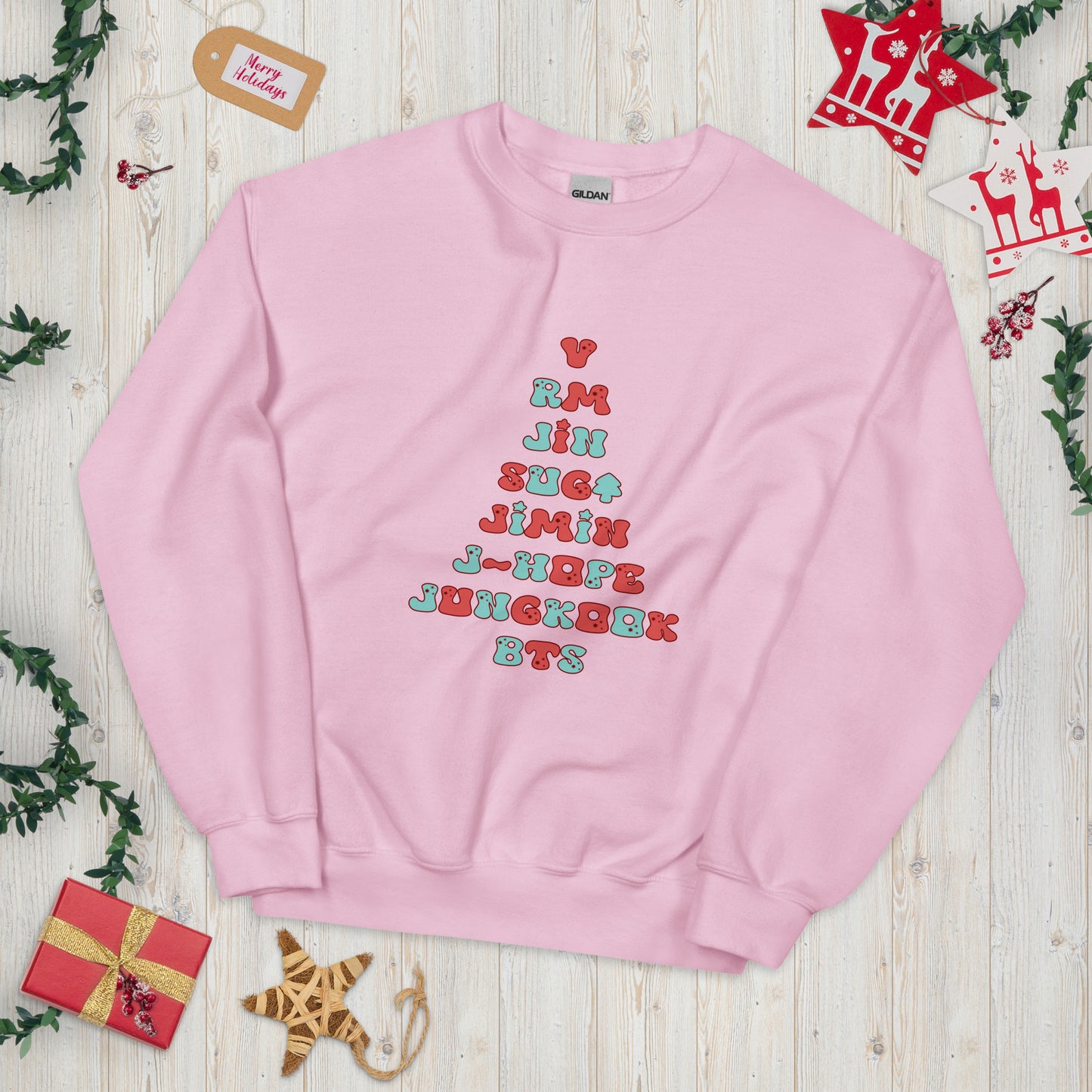 Pink Sweatshirt with all 7 names of BTS arranged to make a Christmas Tree shape.