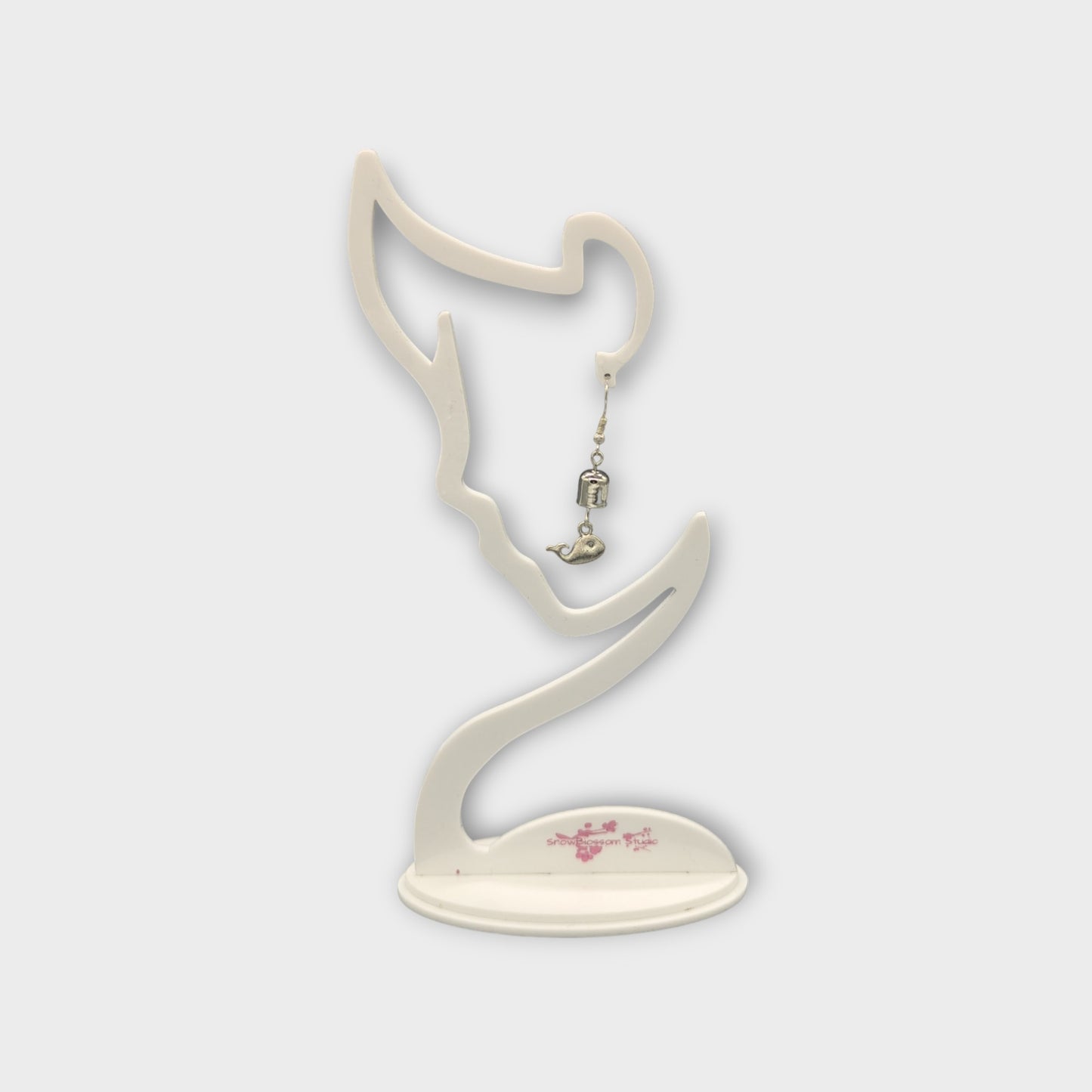 Earrings with a whale and a bell.