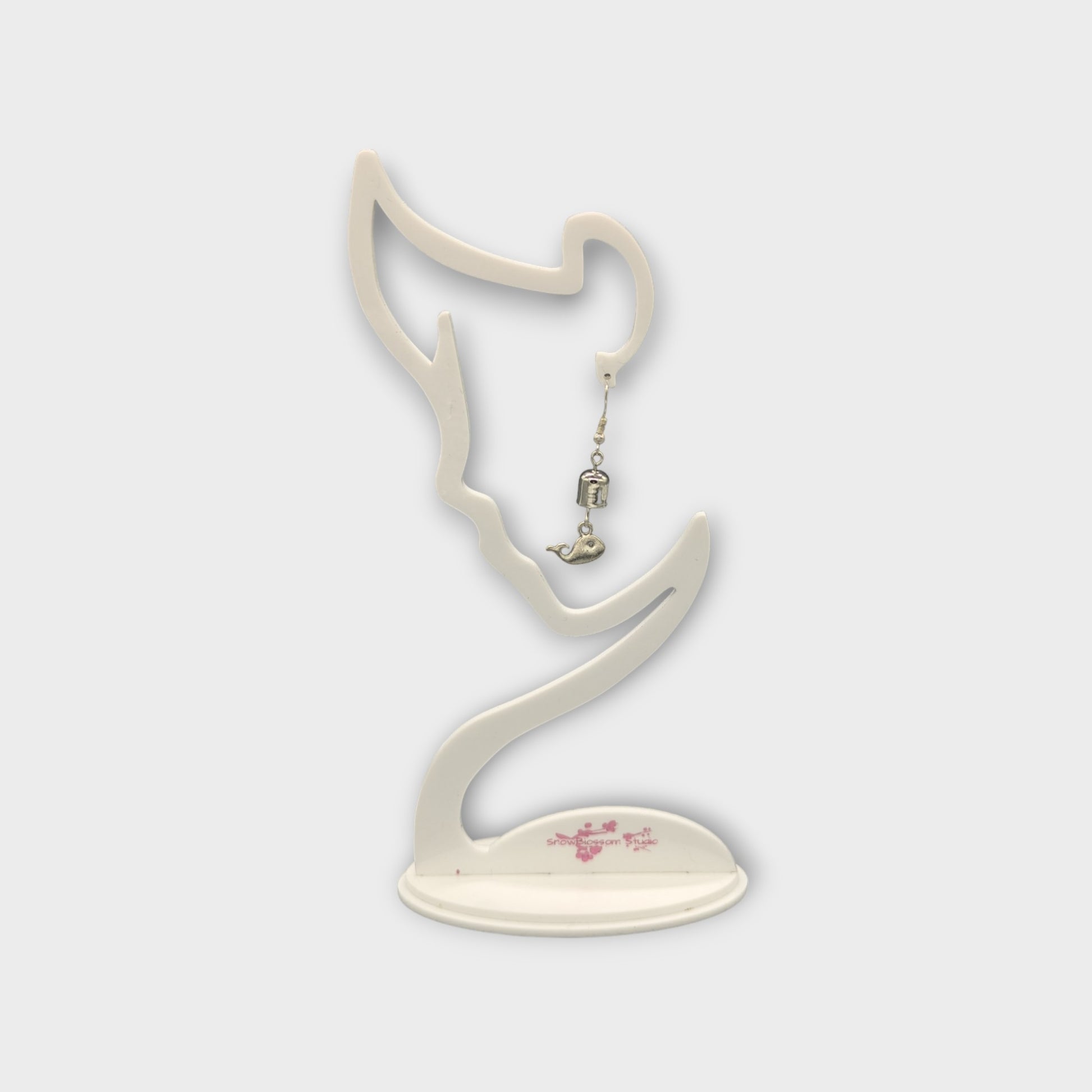 Earrings with a whale and a bell.