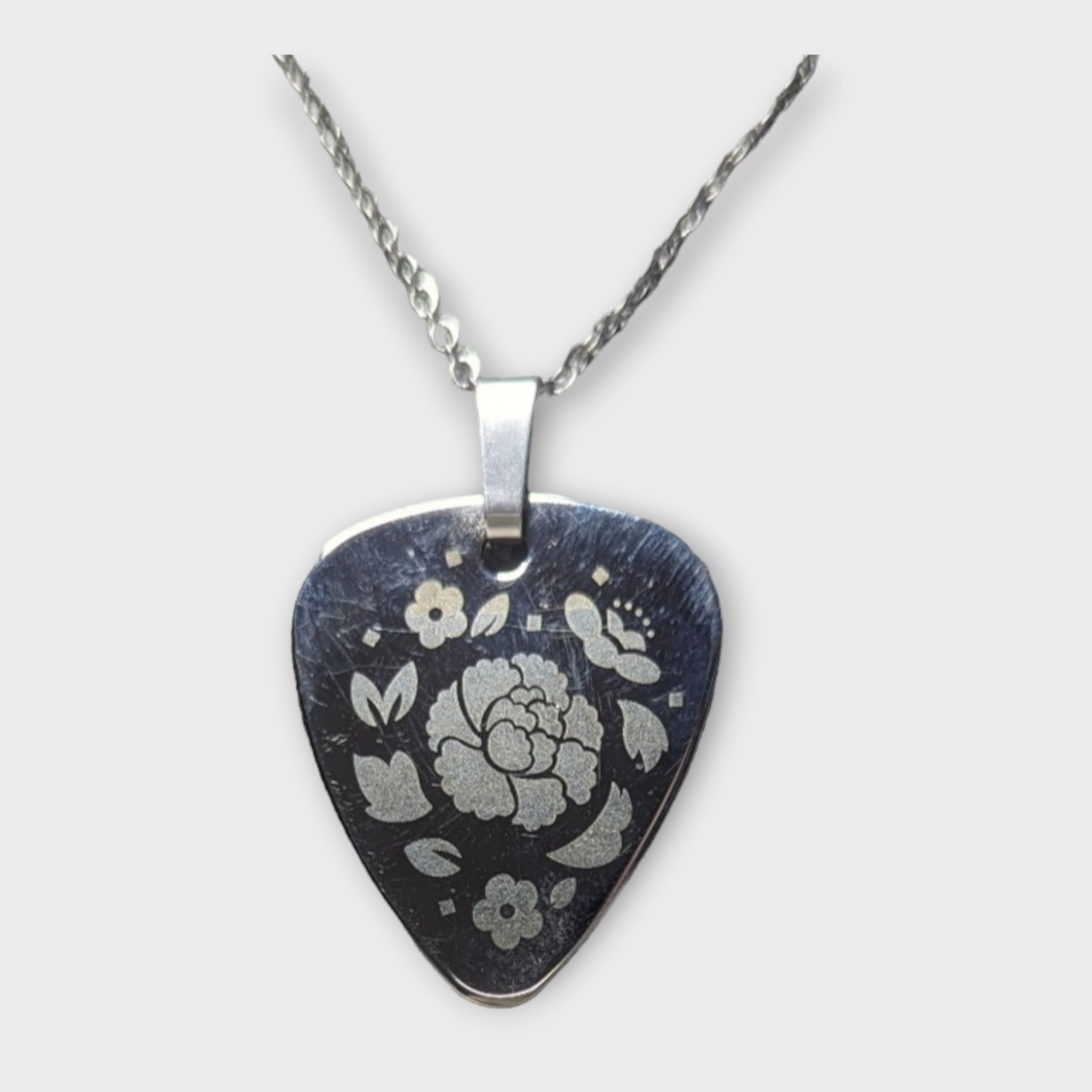 Silver Guitar Pick Pendant engraved with flowers