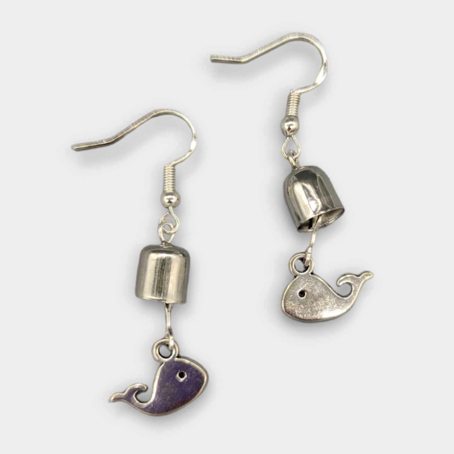 Earrings with a whale and a bell.