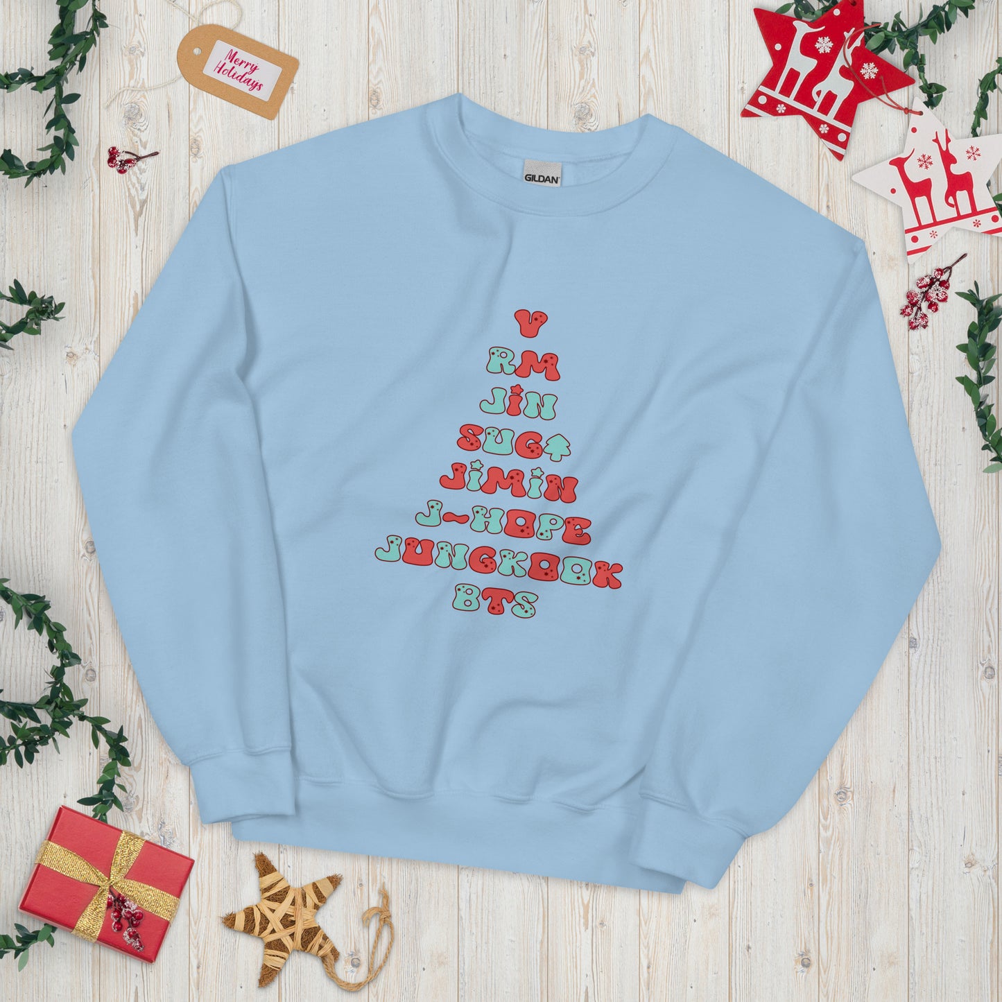 Baby Blue Sweatshirt with all 7 names of BTS arranged to make a Christmas Tree shape. 