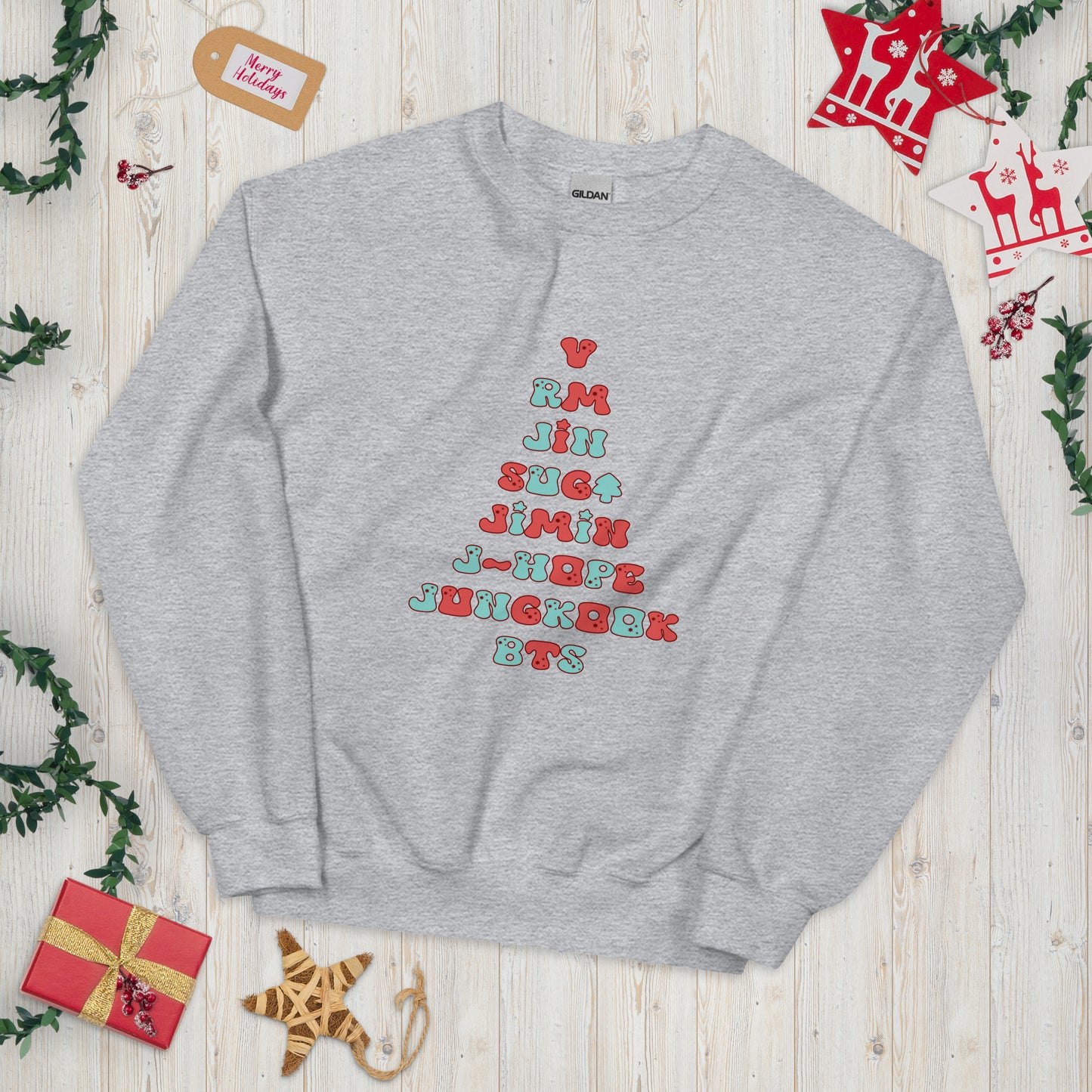 Gray Sweatshirt with all 7 names of BTS arranged to make a Christmas Tree shape. 