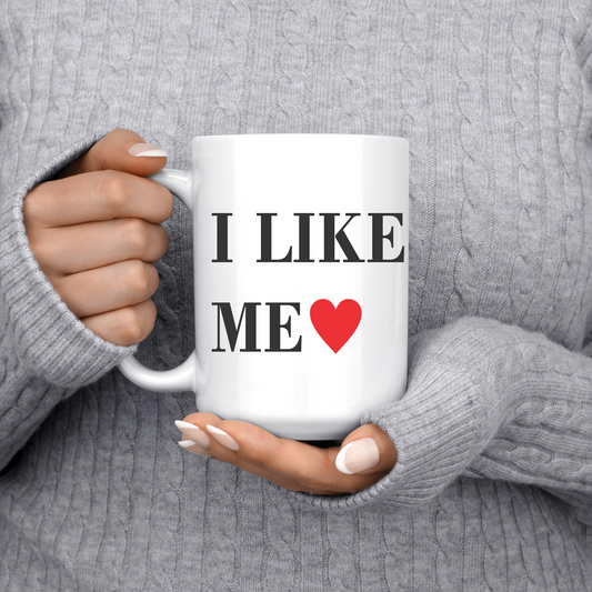 White mug with black writing that reads I Like Me and a red heart.