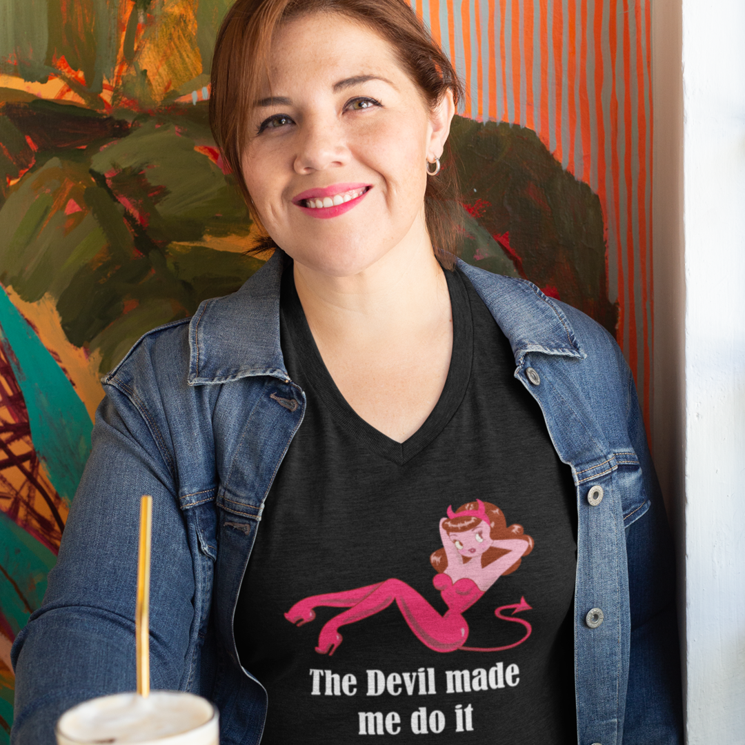 Black T-Shirts with a pinup style female Devil in read pants and corset. The shirt has white text that reads The devil made me do it